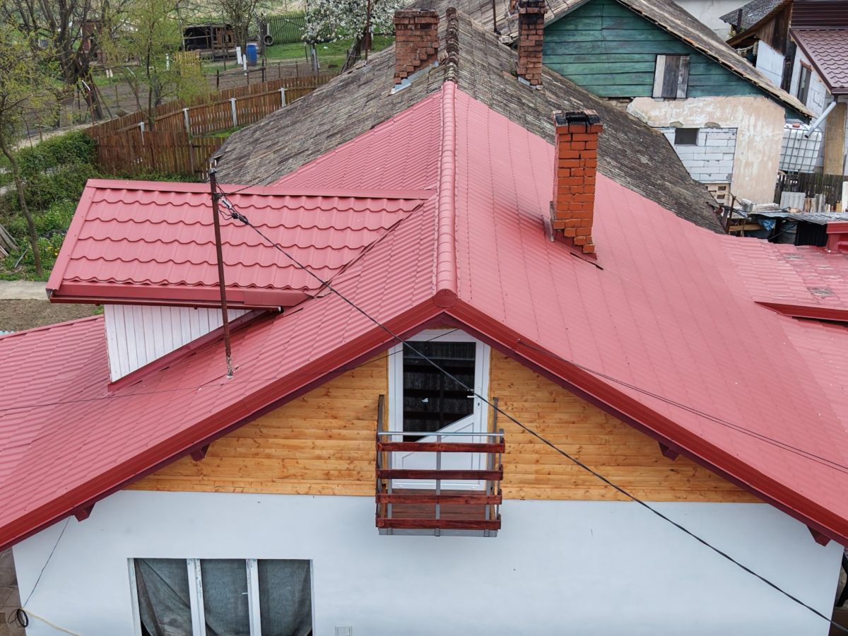 Drone close-up of a tiled roof and balcony during inspection